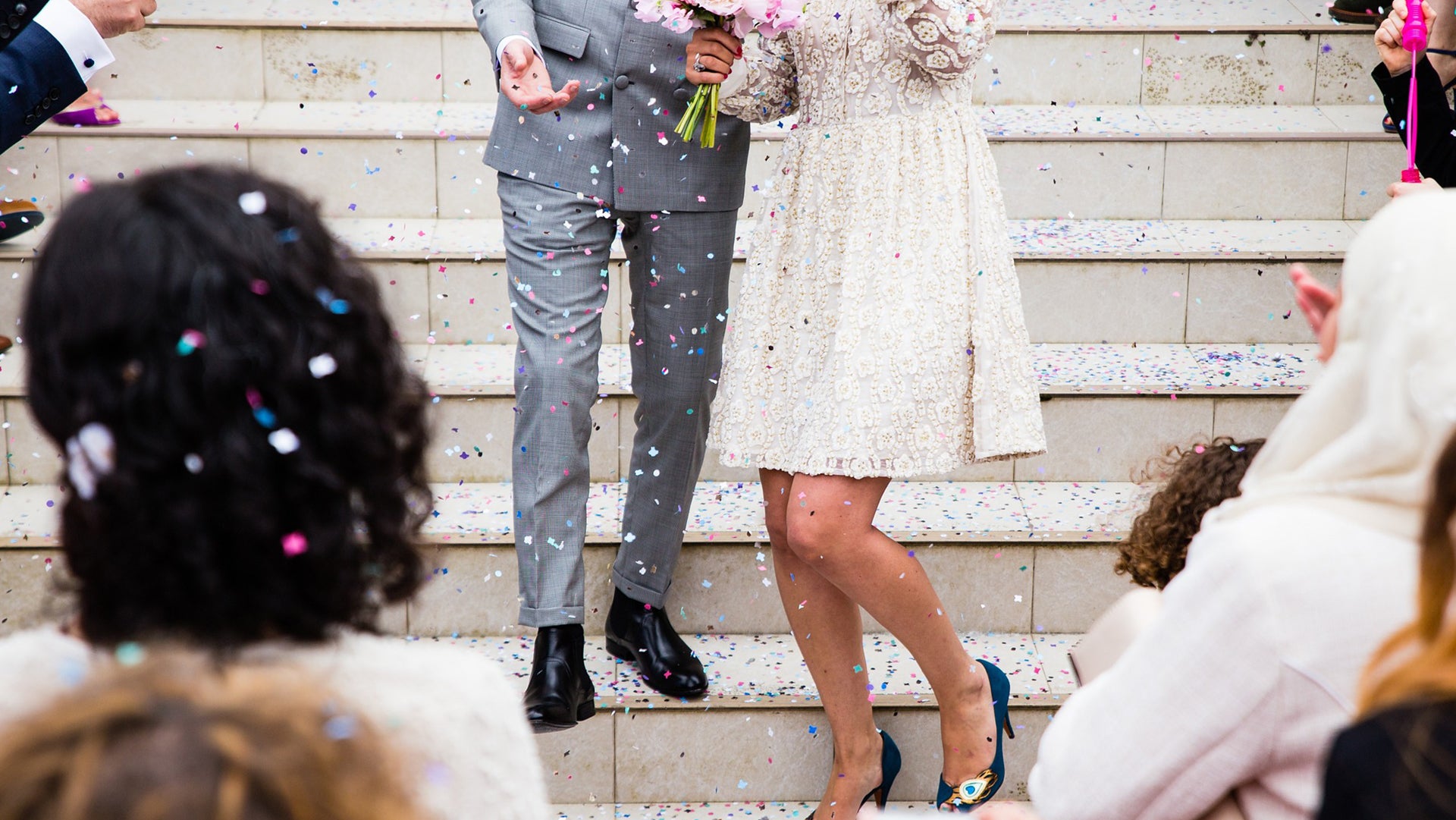Newly married couple standing on steps
